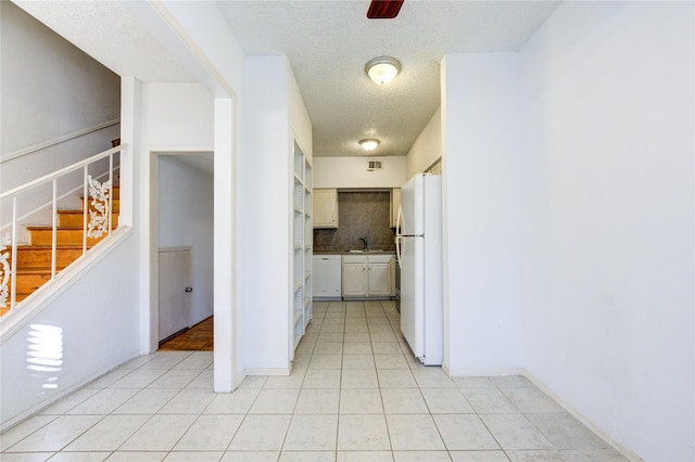 hallway with a textured ceiling