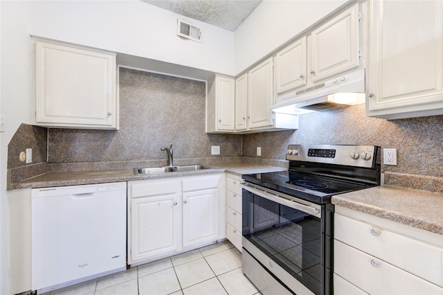 kitchen with white dishwasher, sink, light tile patterned floors, white cabinets, and stainless steel range with electric cooktop