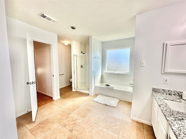 full bathroom with tile patterned floors, vanity, independent shower and bath, and toilet