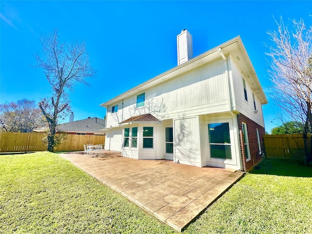 back of property featuring a yard and a patio