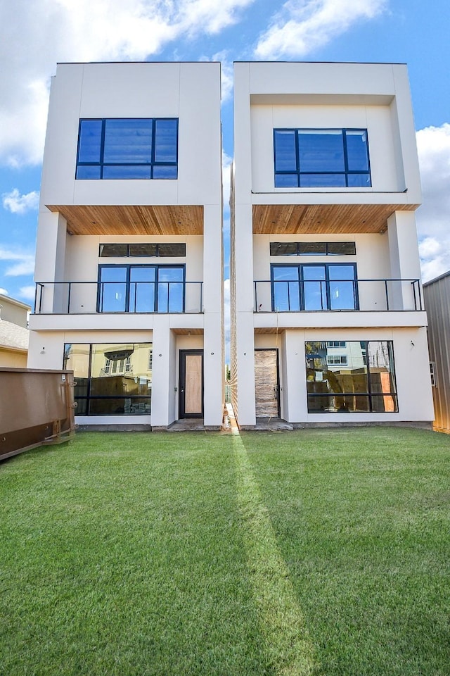 rear view of house with a yard