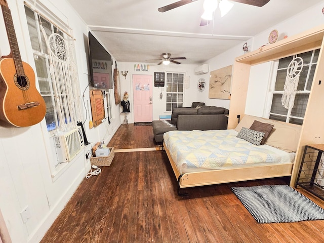 bedroom with a wall mounted AC, ceiling fan, dark hardwood / wood-style flooring, and cooling unit