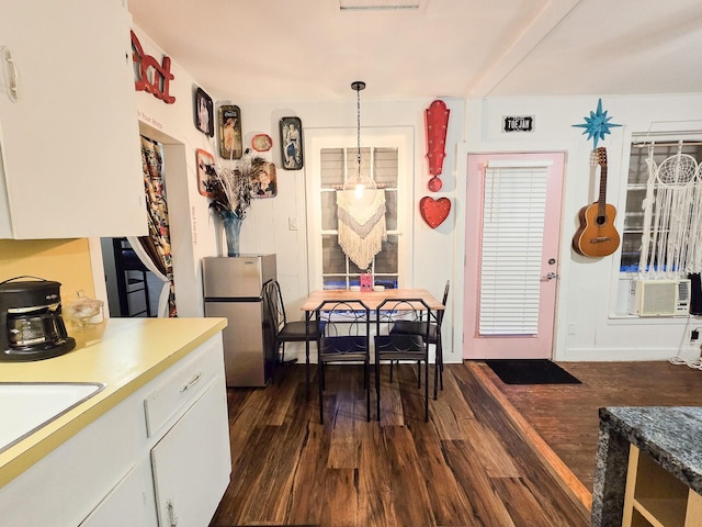 dining space with sink, cooling unit, and dark wood-type flooring