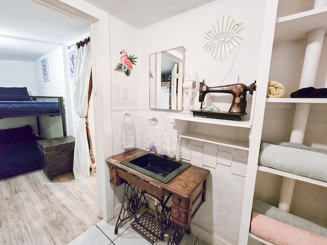 bedroom with light hardwood / wood-style floors and sink