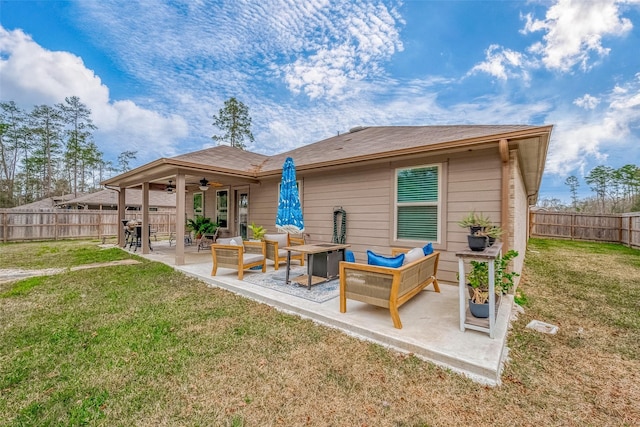 back of property with ceiling fan, an outdoor hangout area, a patio area, and a yard