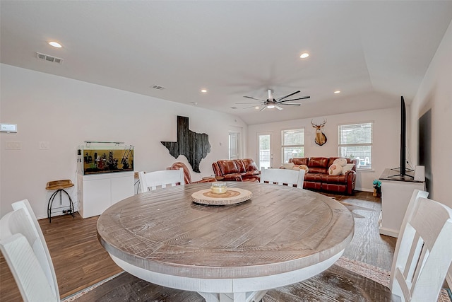 dining room with ceiling fan, dark hardwood / wood-style flooring, and vaulted ceiling