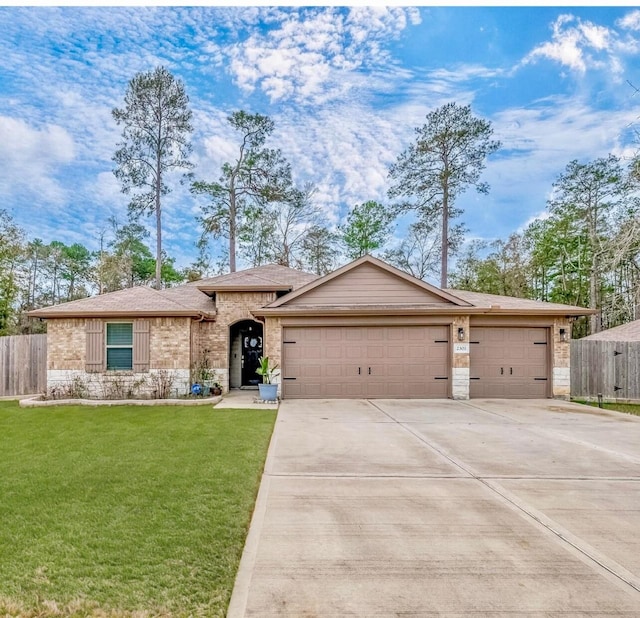 ranch-style house featuring a front yard and a garage