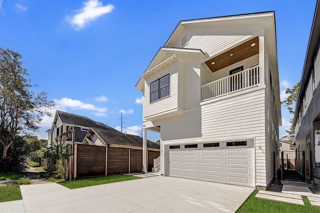 view of side of home featuring a balcony and a garage