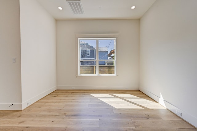 spare room featuring light wood-type flooring