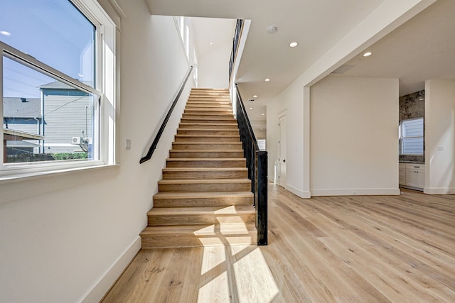 stairs with hardwood / wood-style floors