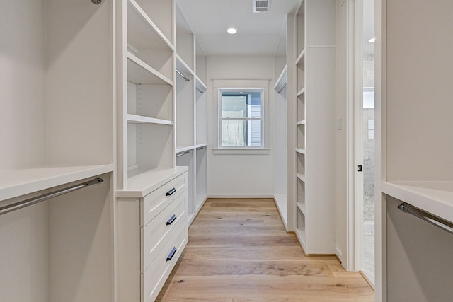 spacious closet featuring light hardwood / wood-style floors