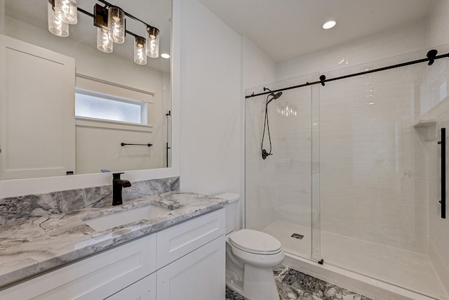 bathroom with vanity, an enclosed shower, and toilet