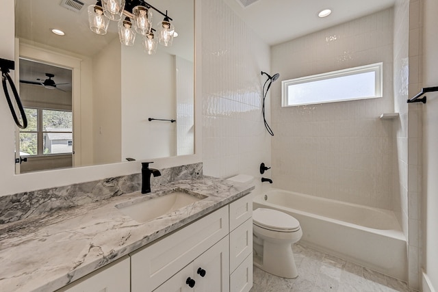 full bathroom with tiled shower / bath combo, ceiling fan, toilet, and vanity