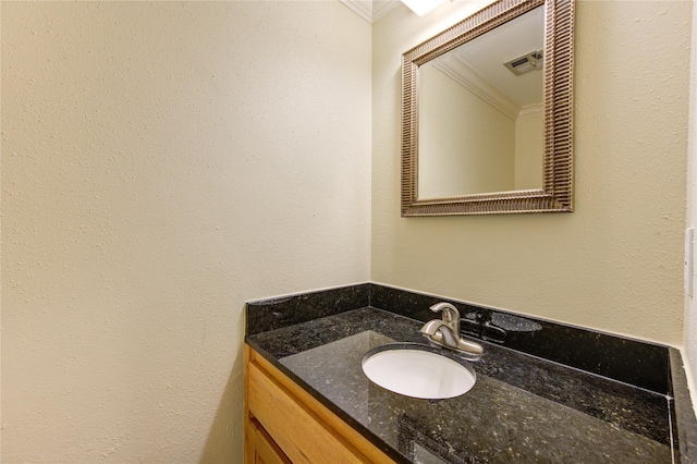 bathroom featuring ornamental molding and vanity