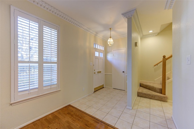 tiled foyer with ornamental molding