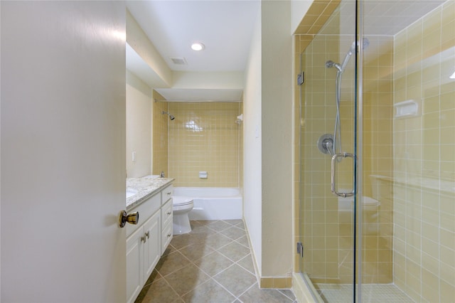 bathroom featuring toilet, a shower with door, vanity, and tile patterned flooring