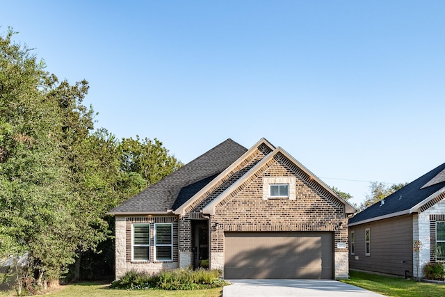 view of front of house featuring a front yard and a garage