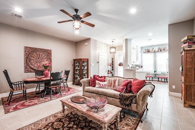 tiled living room with ceiling fan