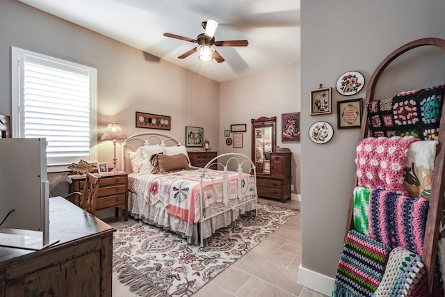 tiled bedroom with ceiling fan