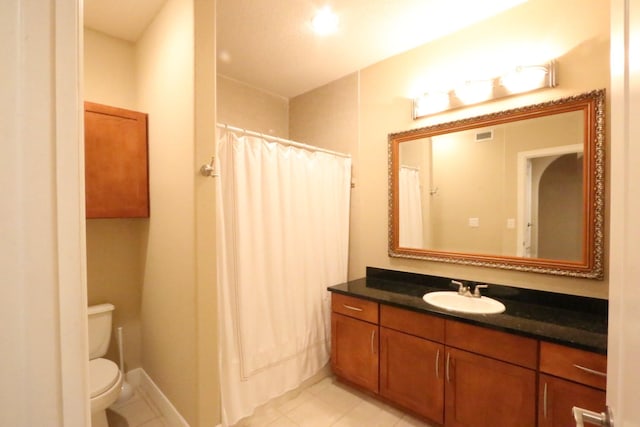 bathroom featuring a shower with shower curtain, vanity, toilet, and tile patterned floors