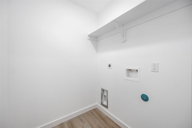 clothes washing area featuring hardwood / wood-style flooring, hookup for an electric dryer, and hookup for a washing machine