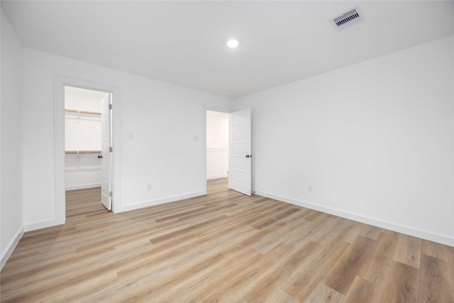 spare room with light hardwood / wood-style flooring