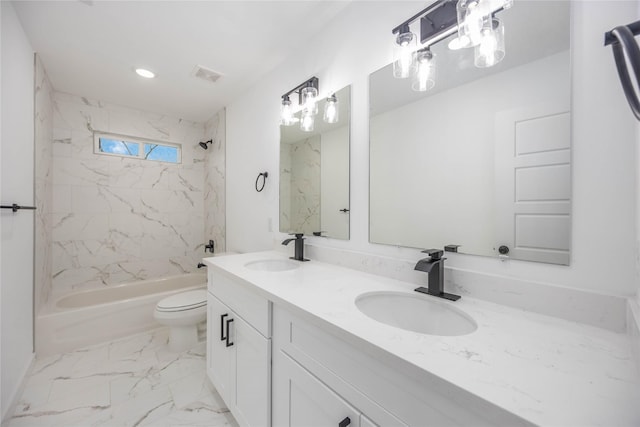 full bathroom with vanity, toilet, and tiled shower / bath