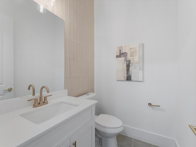 bathroom with tile patterned flooring, vanity, and toilet