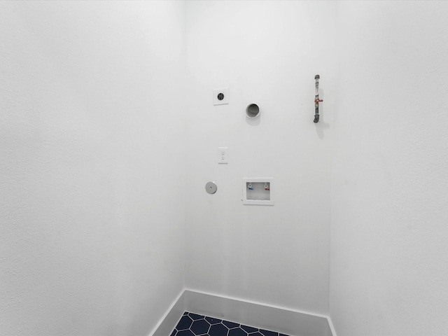 washroom with electric dryer hookup, hookup for a gas dryer, dark tile patterned floors, and washer hookup