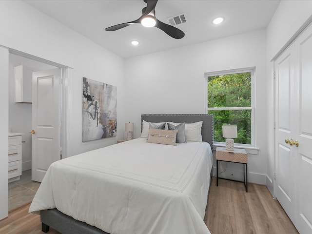 bedroom with ceiling fan and light hardwood / wood-style flooring