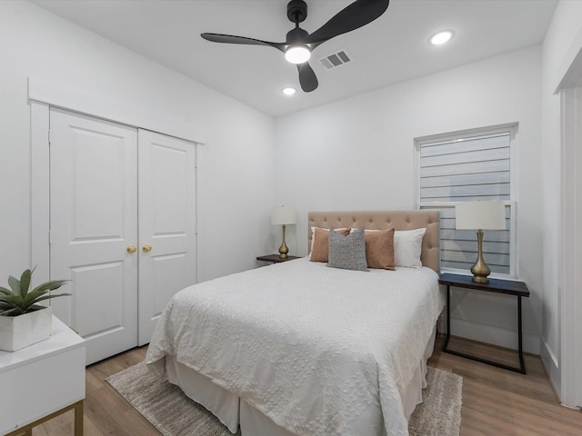 bedroom featuring ceiling fan, a closet, and hardwood / wood-style floors