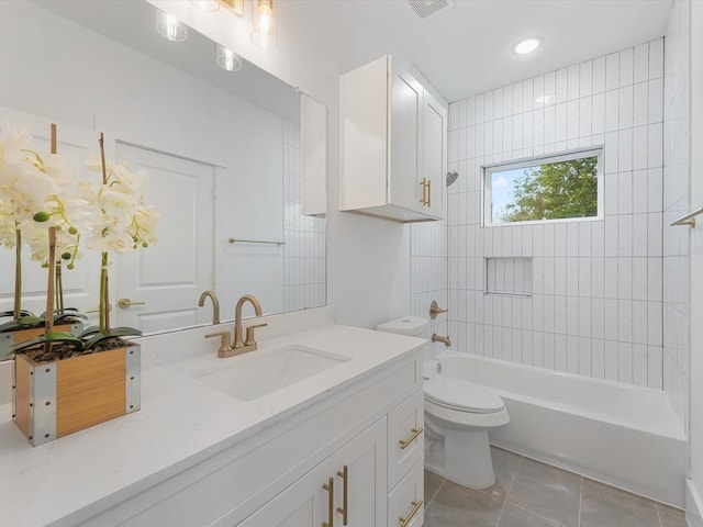 full bathroom featuring tile patterned floors, vanity, toilet, and tiled shower / bath