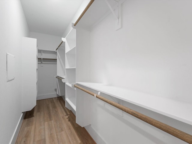 spacious closet with light hardwood / wood-style floors