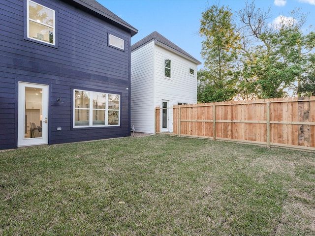 back of house featuring a yard