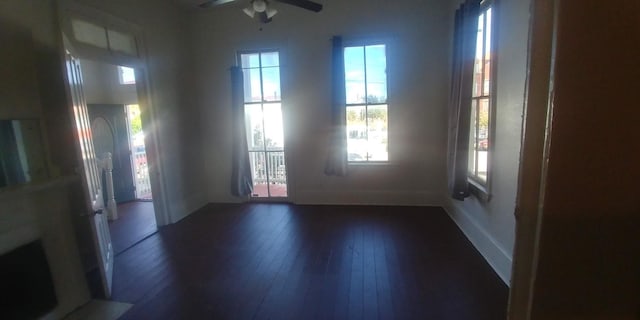 unfurnished room featuring dark hardwood / wood-style floors and ceiling fan