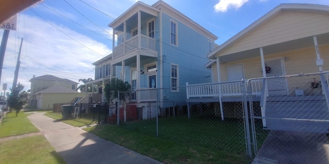 exterior space with a balcony and a front lawn