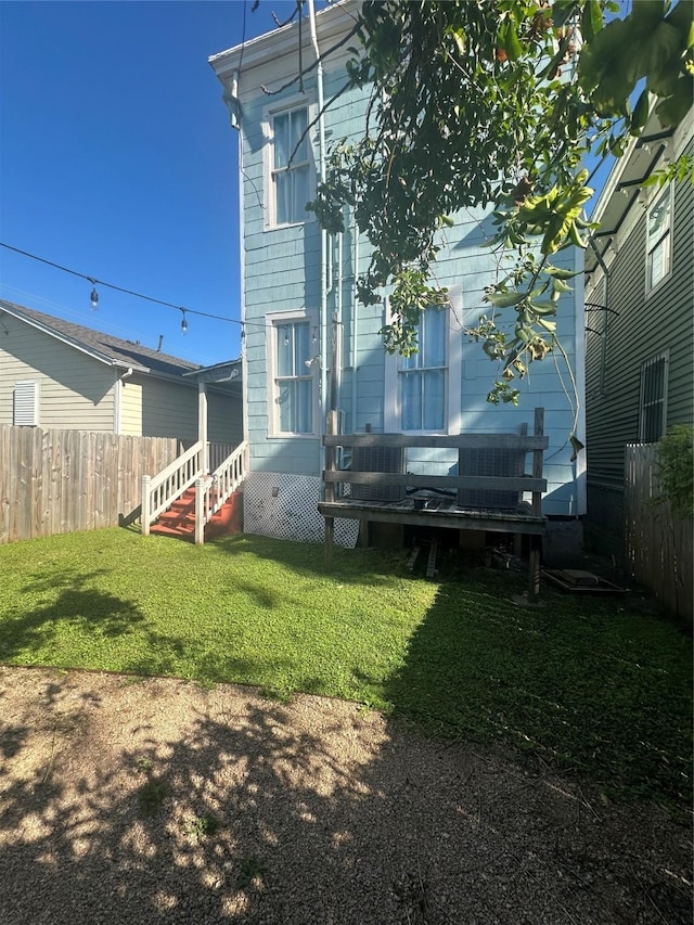 view of yard with cooling unit and a wooden deck