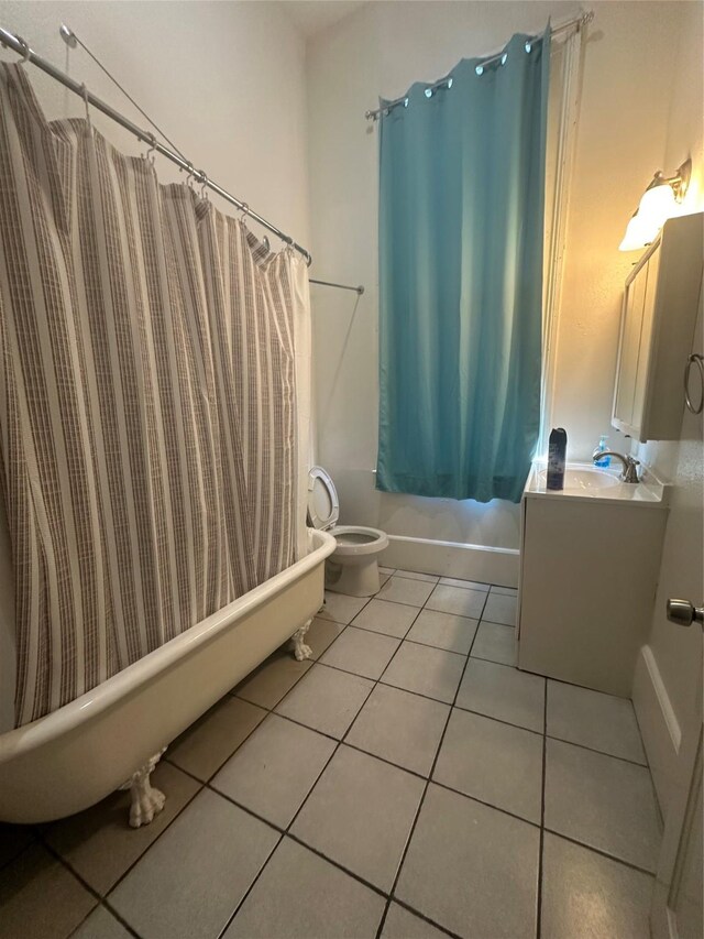 full bathroom featuring vanity, shower / tub combo, tile patterned floors, and toilet