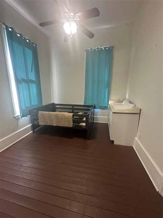 bedroom featuring dark hardwood / wood-style floors and ceiling fan