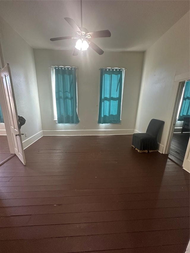 spare room featuring ceiling fan and dark hardwood / wood-style flooring