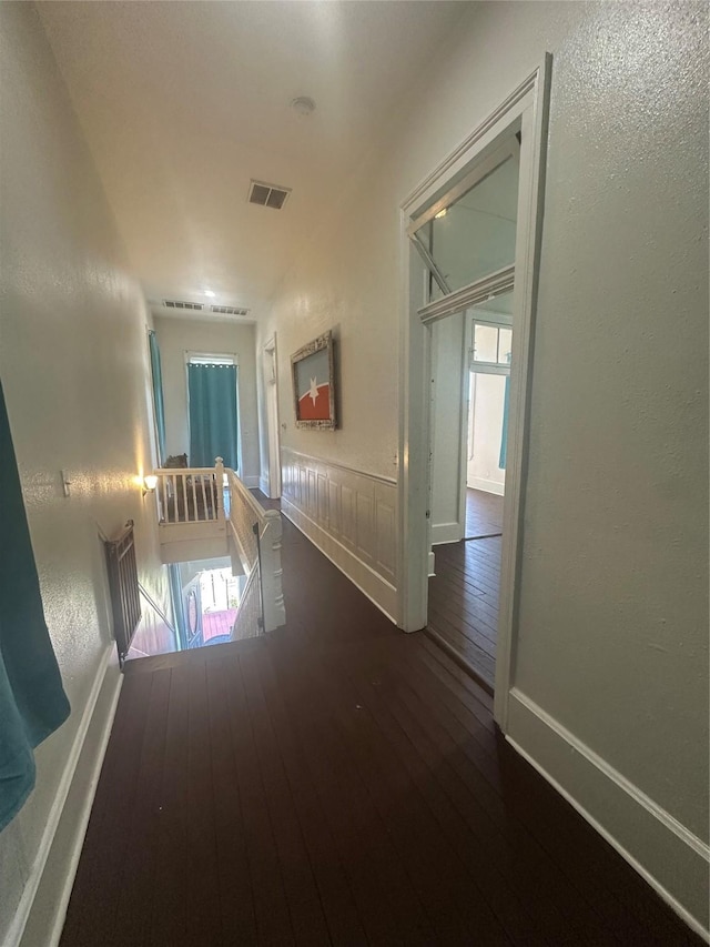 hall with dark hardwood / wood-style floors