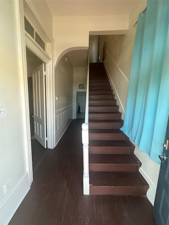 staircase with hardwood / wood-style flooring