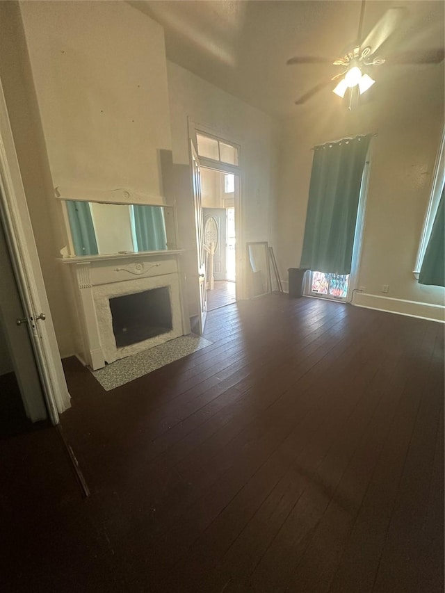 unfurnished living room featuring hardwood / wood-style floors and ceiling fan