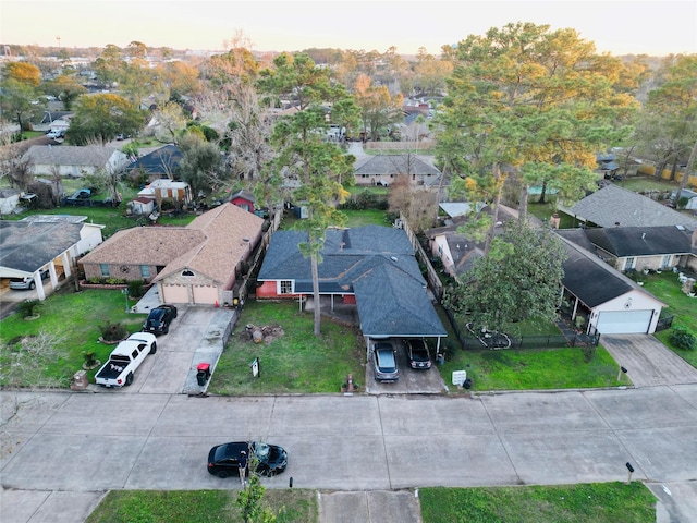 aerial view at dusk featuring a residential view