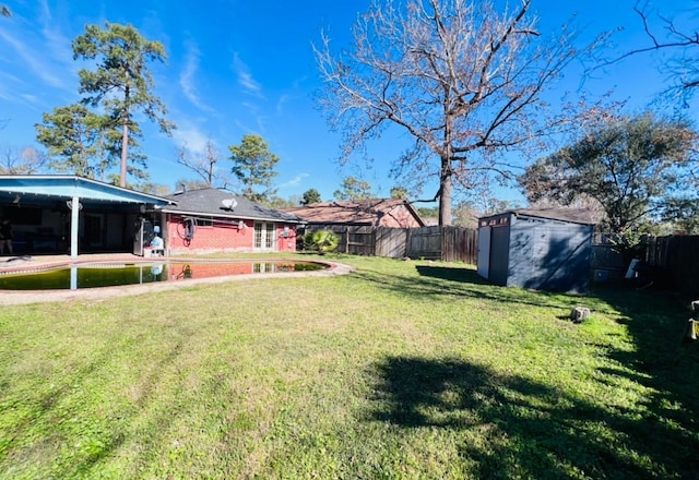 view of yard with a patio and a storage unit