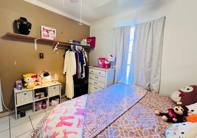 bedroom with light tile patterned flooring and ornamental molding