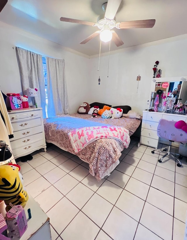 tiled bedroom featuring ceiling fan