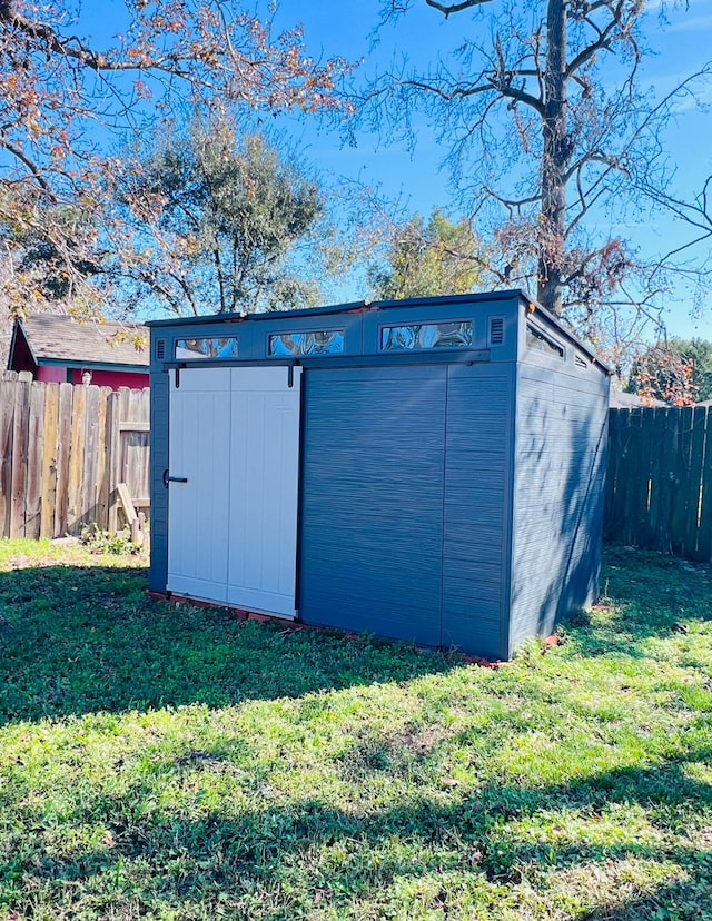 view of outbuilding with a lawn