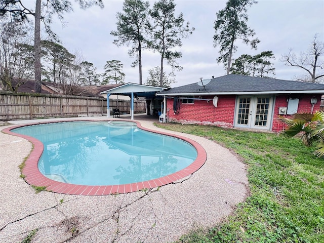 view of pool with a yard, fence, a fenced in pool, and a gazebo