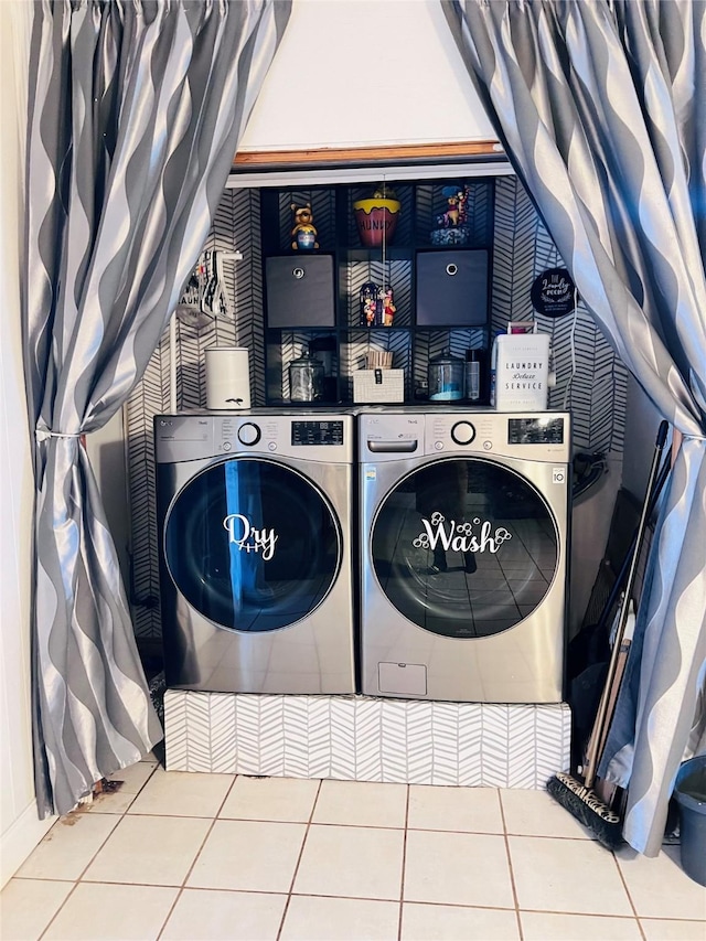 laundry area featuring laundry area, tile patterned flooring, and washing machine and clothes dryer